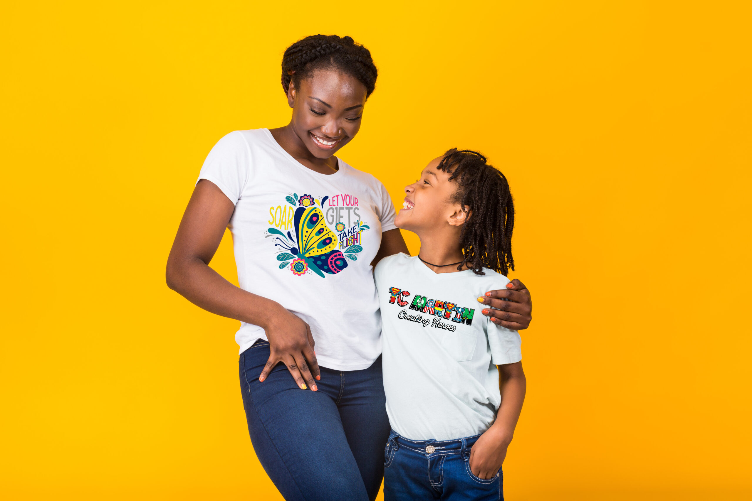 Black mom with her kid wearing white t-shirt and jeans, posing in minimalist street fashion style, family same look